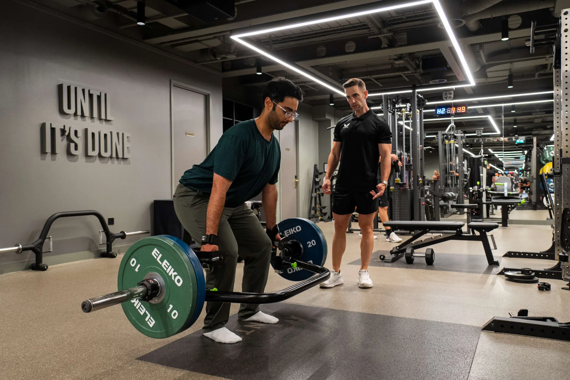 Maurizio coaching a client through a trap bar deadlift at a private, premium training facility in Marylebone